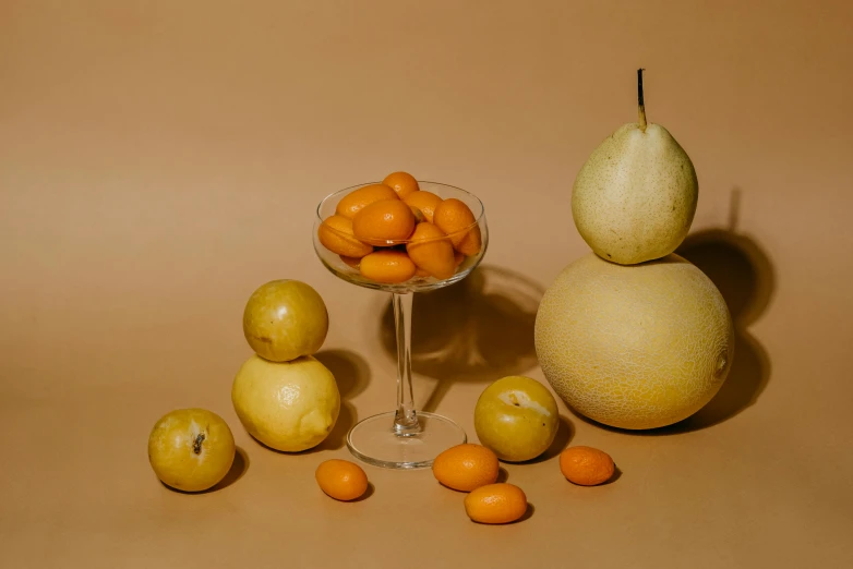 a group of fruit sitting on top of a table, a still life, by Doug Ohlson, unsplash contest winner, pale orange colors, inflateble shapes, glass orbs, smooth oval head