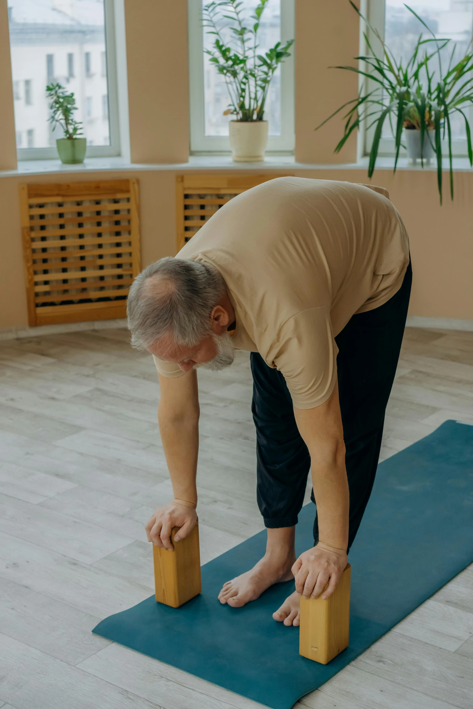 a man is bending over on a yoga mat, pexels contest winner, renaissance, portrait of hide the pain harold, low quality photo, brown, full body with dynamic pose