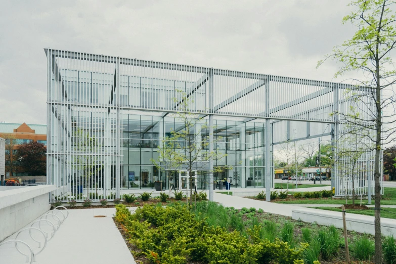 a large glass building sitting in the middle of a park, inspired by Tadao Ando, unsplash, vancouver school, entrance, canopies, southdale center, in bloom greenhouse