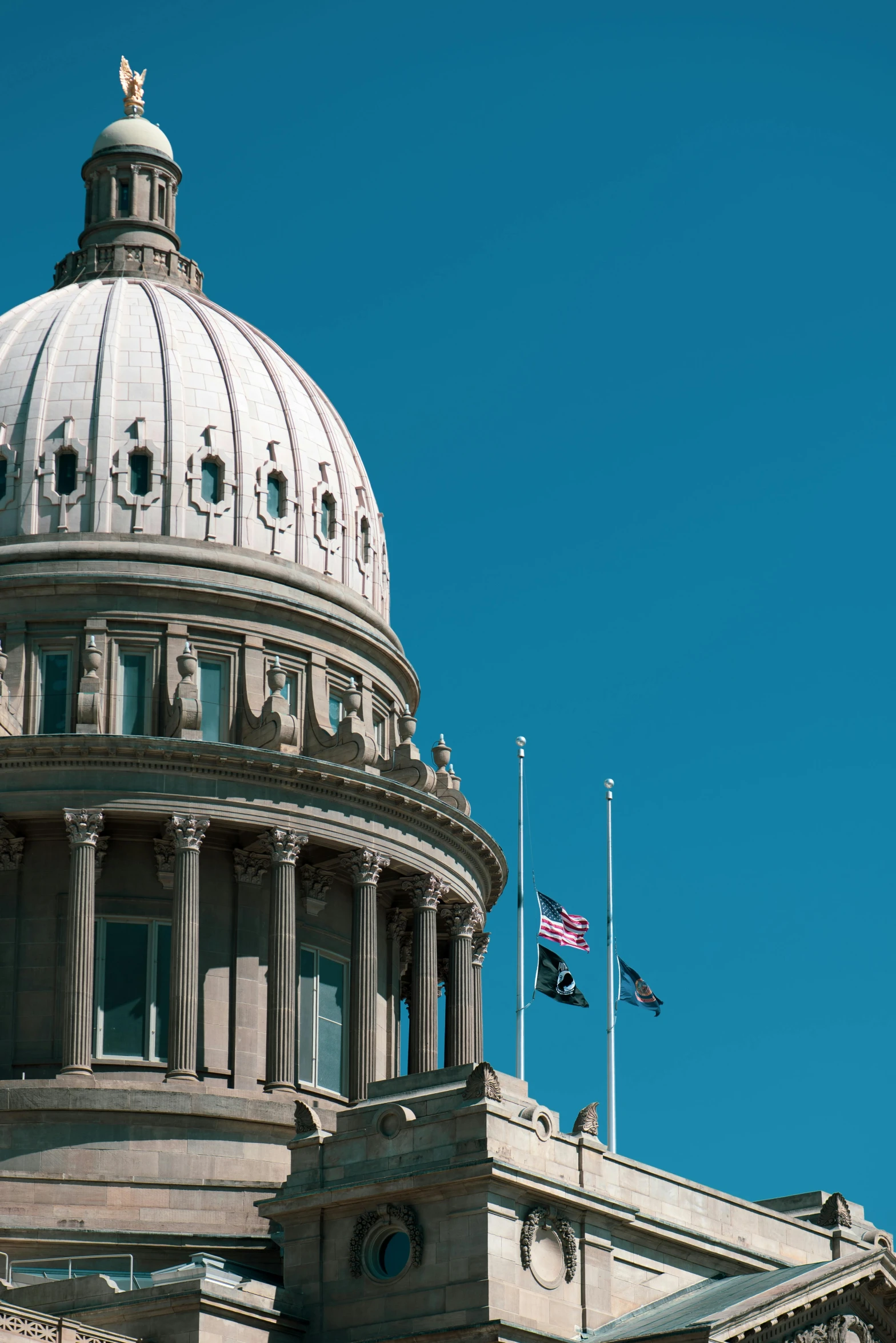 a large building with a clock on top of it, flags, idaho, capitol building, profile image