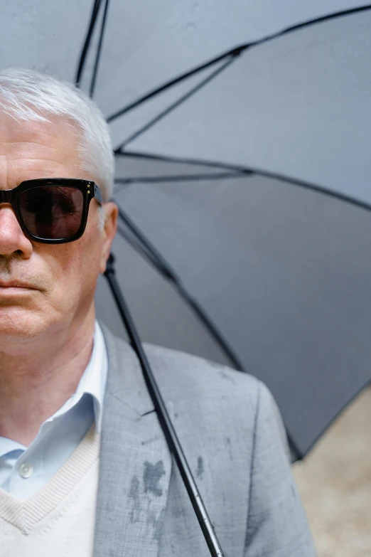 a man in a suit and sunglasses holding an umbrella, by Graham Forsythe, blinding white hair, jury, darren shaddick, thumbnail