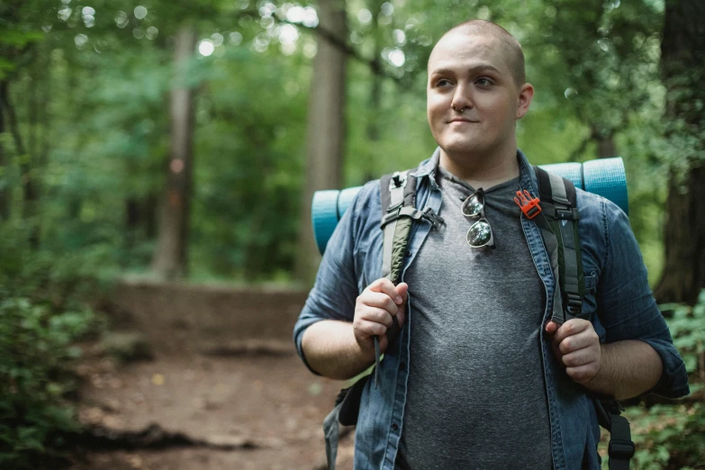 a man with a backpack on a trail in the woods, a portrait, by Adam Marczyński, shutterstock, partially bald, avatar image, slightly overweight, young adult male