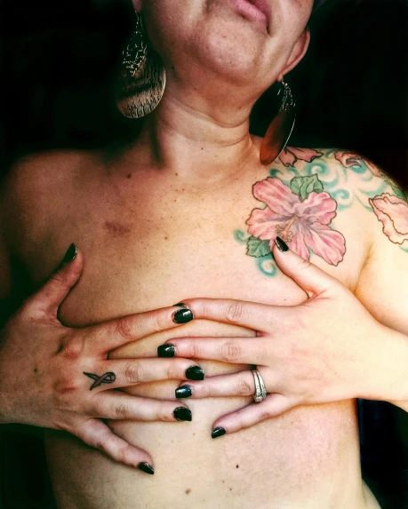 a woman with a tattoo on her chest, by Morgan Russell, transgressive art, lgbtq, low quality photo, multiple stories, (heart)
