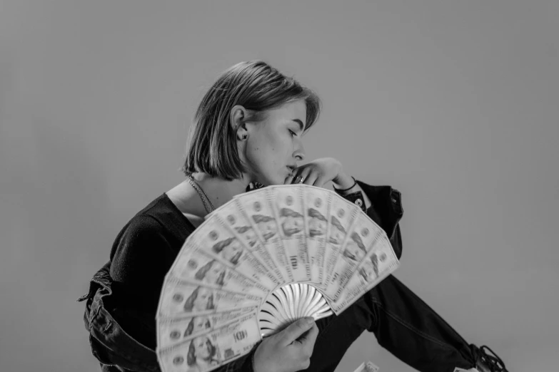 a black and white photo of a woman holding a fan, by Alejandro Obregón, pexels contest winner, realism, asian woman made from origami, maisie williams, caravaggio style, promotional image