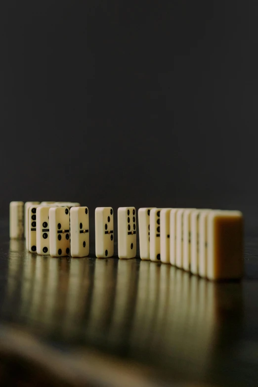 a row of dominos sitting on top of a table, a picture, unsplash, digital art, carved ivory, series, performance, opening shot