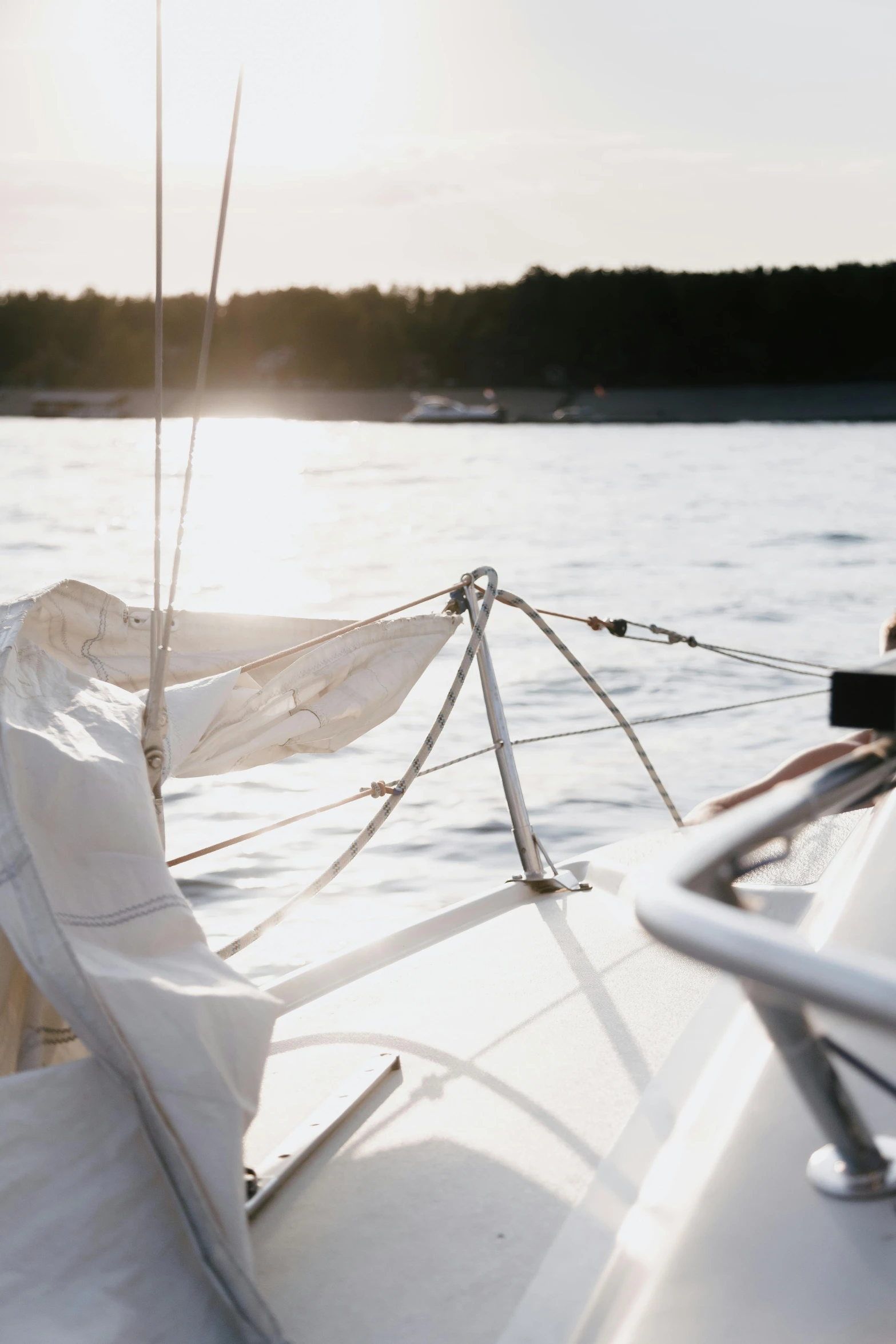 a close up of a sail boat on a body of water, happening, finland, sun overhead, softly - lit, afternoon hangout