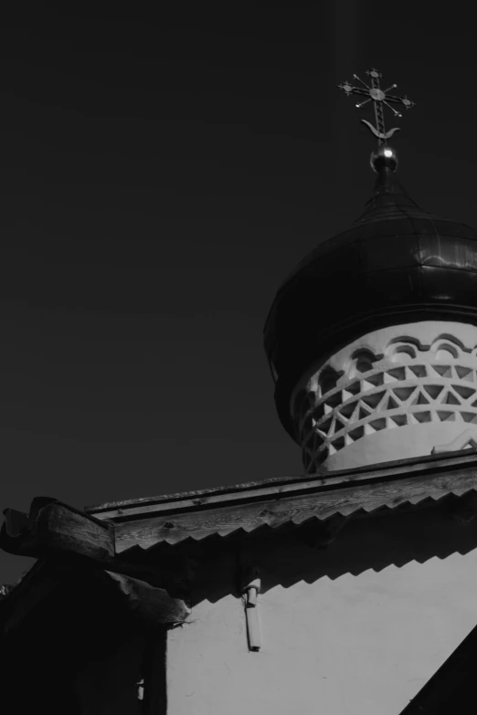 a black and white photo of a church, inspired by Pavel Fedotov, unsplash, baroque, pointy conical hat, russian and japanese mix, detail, the moon on the top right