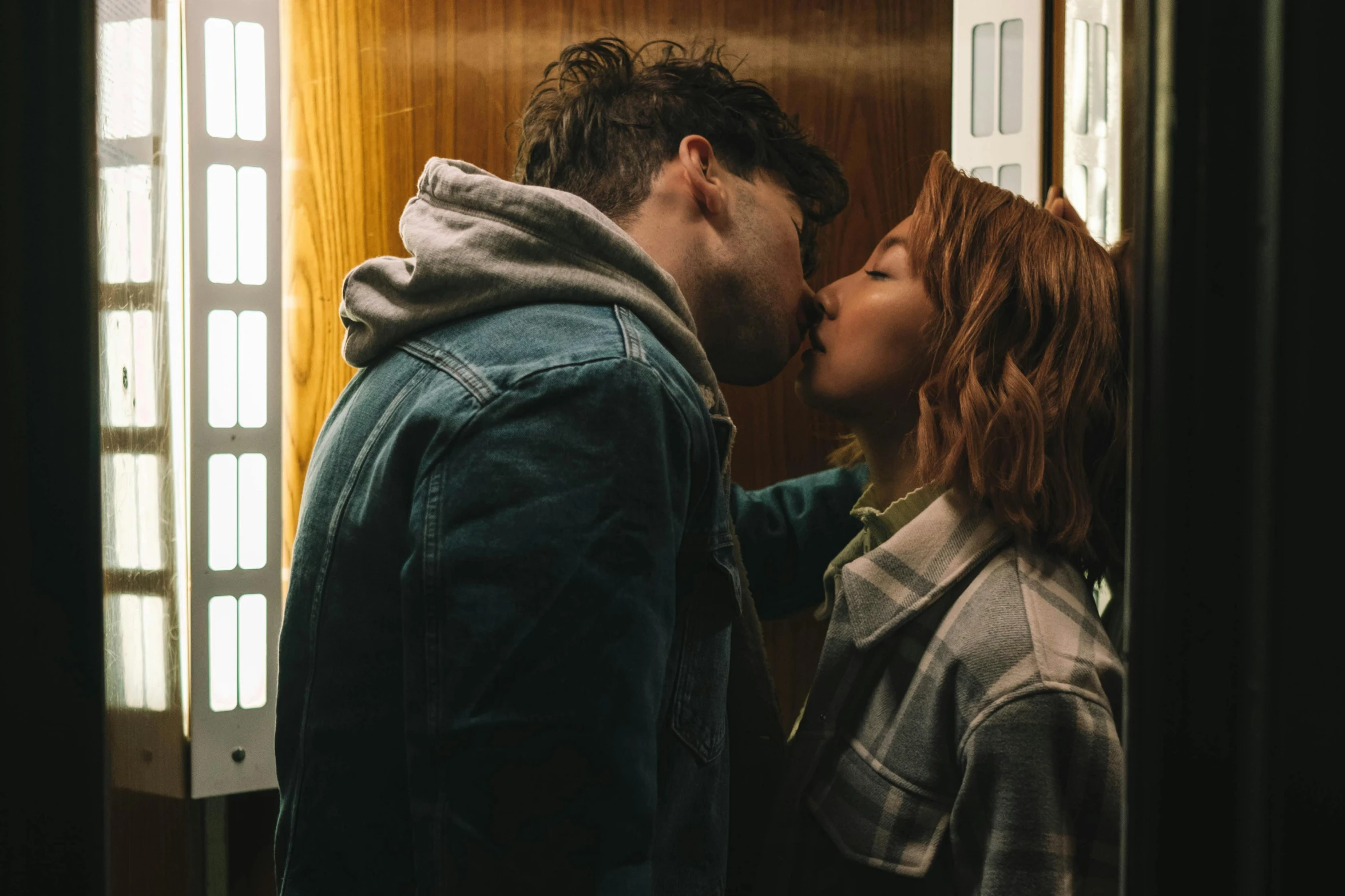 a man and a woman kissing in an elevator, trending on pexels, portrait of max caulfield, ( redhead, kodak portra film, ignant