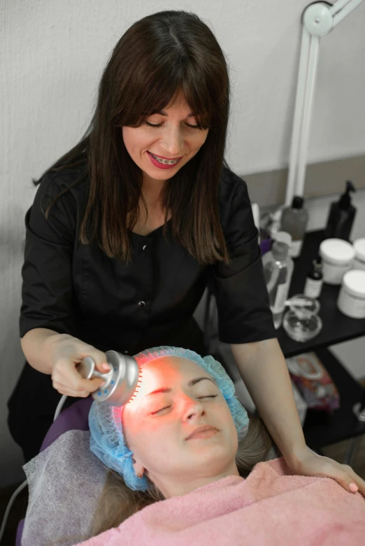a woman getting a facial treatment at a beauty salon, by Natasha Tan, renaissance, led effects, silver skin, deep colour, crown of (white lasers)