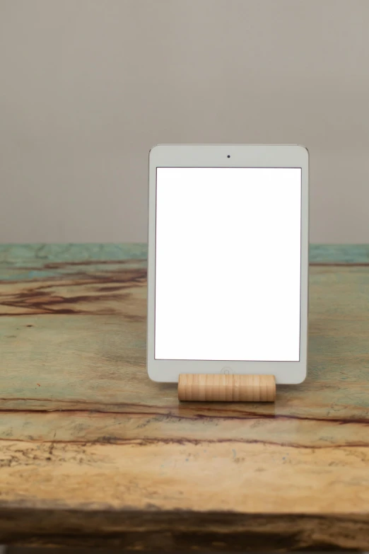 a tablet computer sitting on top of a wooden table, by Jessie Algie, modernism, white, small, 0, light wood