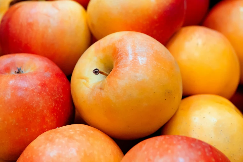 a pile of apples sitting on top of each other, by Jan Rustem, unsplash, pale orange colors, she is easting a peach, thumbnail, close-up product photo