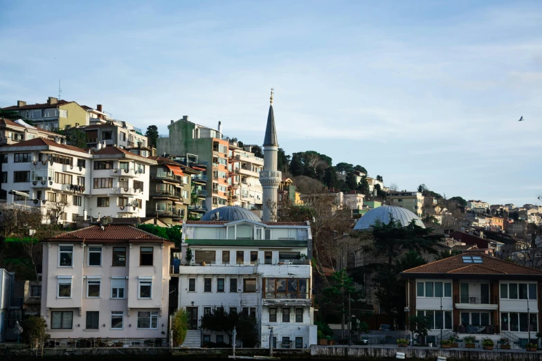 a number of buildings near a body of water, a photo, inspired by Yasar Vurdem, pexels contest winner, in the hillside, lead - covered spire, turkish and russian, ballard