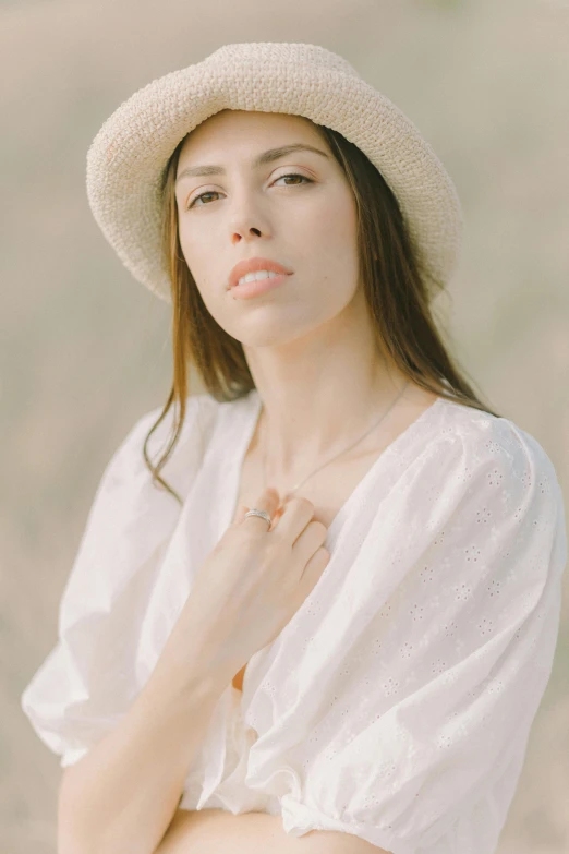 a woman wearing a hat standing in a field, an album cover, inspired by Josefina Tanganelli Plana, trending on pexels, renaissance, wearing jewelry, ana de armas portrait, white, promotional image