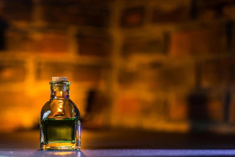 a bottle of alcohol sitting on top of a counter, a picture, by Jesper Knudsen, unsplash, renaissance, made of glowing oil, glowing green, slide show, alembic