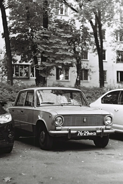 a couple of cars parked next to each other, an album cover, by Sven Erixson, unsplash, socialist realism, russian lada car, tri - x 4 0 0 tx, square, low quality photo