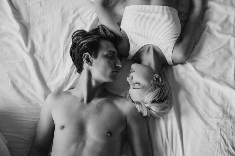 a man and a woman laying on a bed, a black and white photo, by Matija Jama, pexels, renaissance, 🌸 🌼 💮, nick silva and ilya kuvshinov, a blond, slim