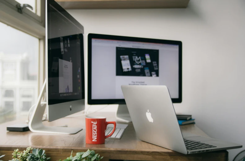 a laptop computer sitting on top of a wooden desk, trending on pexels, monitors, red and white color theme, apple design, thumbnail