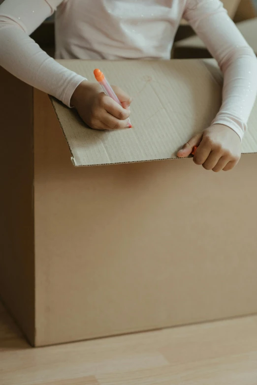 a little girl that is sitting in a box, a child's drawing, pexels contest winner, brown paper, bulky build, thumbnail, packaging