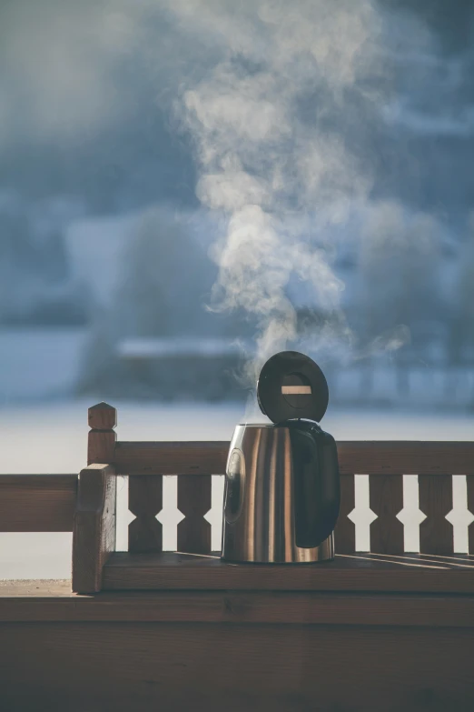 a kettle sitting on top of a wooden bench, by Jesper Knudsen, pexels contest winner, romanticism, ski masks, steamy, (3 are winter, sitting