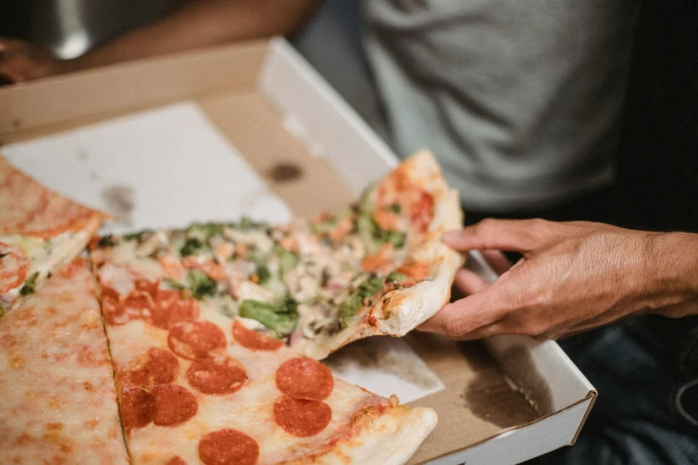 a person taking a slice of pizza out of a box, profile image, fan favorite, close - up photo, no watermarks