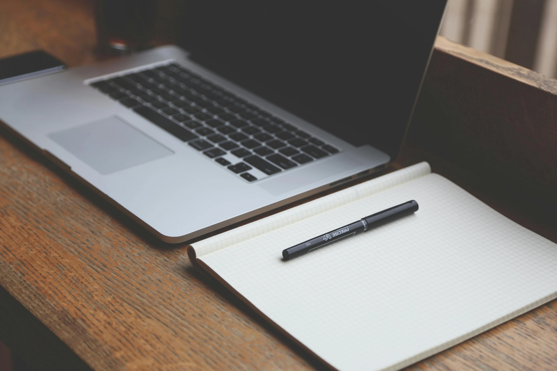 a laptop computer sitting on top of a wooden desk, a sketch, unsplash, black ball pen on white paper, 9 9 designs, laptops