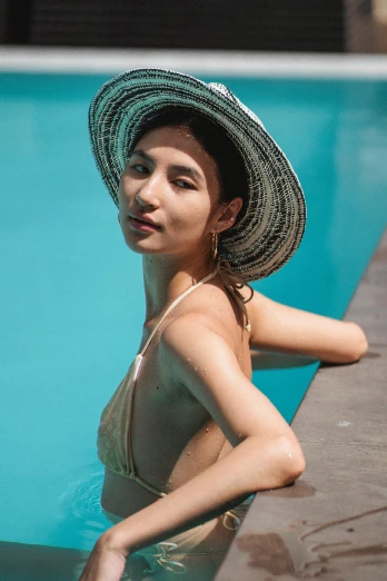 a woman sitting in a pool wearing a hat, pexels contest winner, renaissance, young middle eastern woman, gemma chan, decolletage, promo image