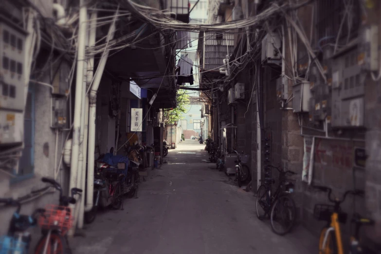 a narrow alley with bicycles parked on both sides, an album cover, by Fei Danxu, fan favorite, hazy, 8 5 mm photograph, 中 元 节