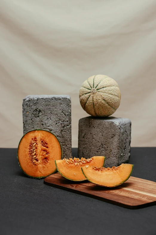 a wooden cutting board topped with slices of melon, a still life, inspired by Lucas van Leyden, unsplash, surrealism, cinder blocks, orange rocks, rusticated stone base, detailed product image