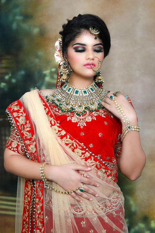 a woman in a red and gold sari, with professional makeup, vibrant red and green colours, wearing jewellery, dramatic lighting !n-9