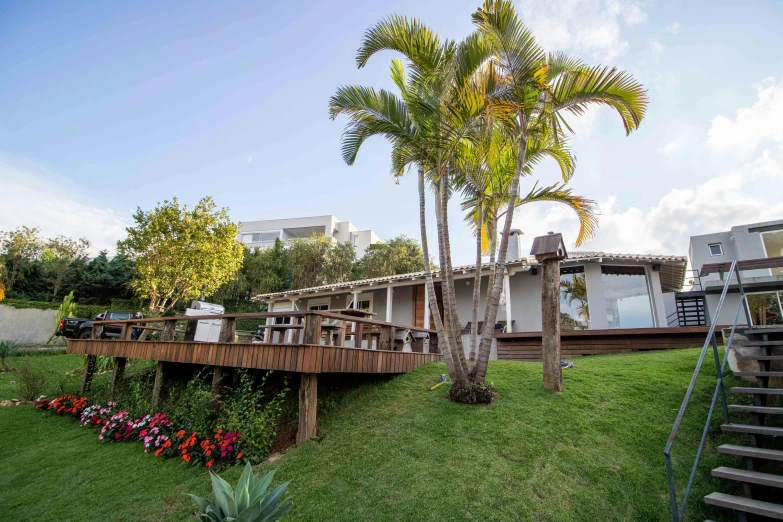 a house sitting on top of a lush green field, by Felipe Seade, plants and patio, beachfront, profile image, oscar niemeyer