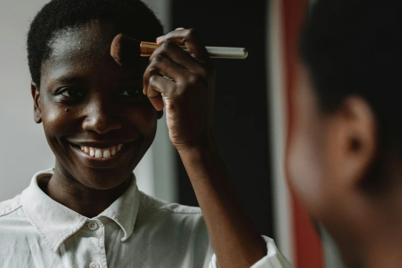 a woman brushing her hair in front of a mirror, pexels contest winner, afrofuturism, greta thunberg smiling, with professional makeup, black teenage boy, unmistakably kenyan