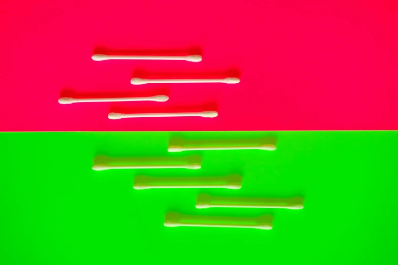 a group of toothbrushes sitting on top of a green and pink background, an album cover, inspired by Lucio Fontana, generative art, stereogram, red and white neon, three fourths view, bones joints