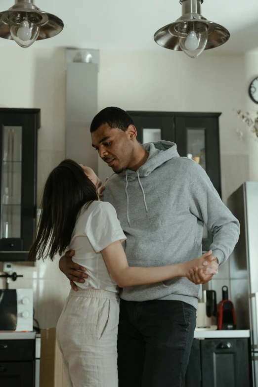 a man standing next to a woman in a kitchen, kissing each other, diverse, r&b, thin young male