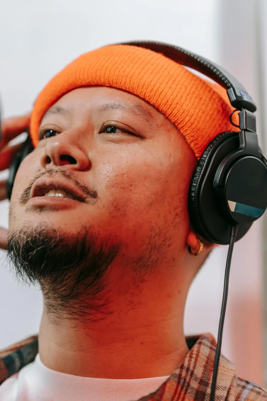 a close up of a person wearing headphones, inspired by Zhu Da, trending on pexels, naranbaatar ganbold, wearing a headband, demna gvasalia, gaming