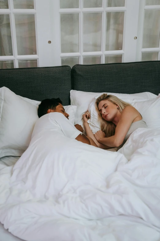 a couple of people laying on top of a bed, white pillows, sleeping beauty, sydney hanson, roomies