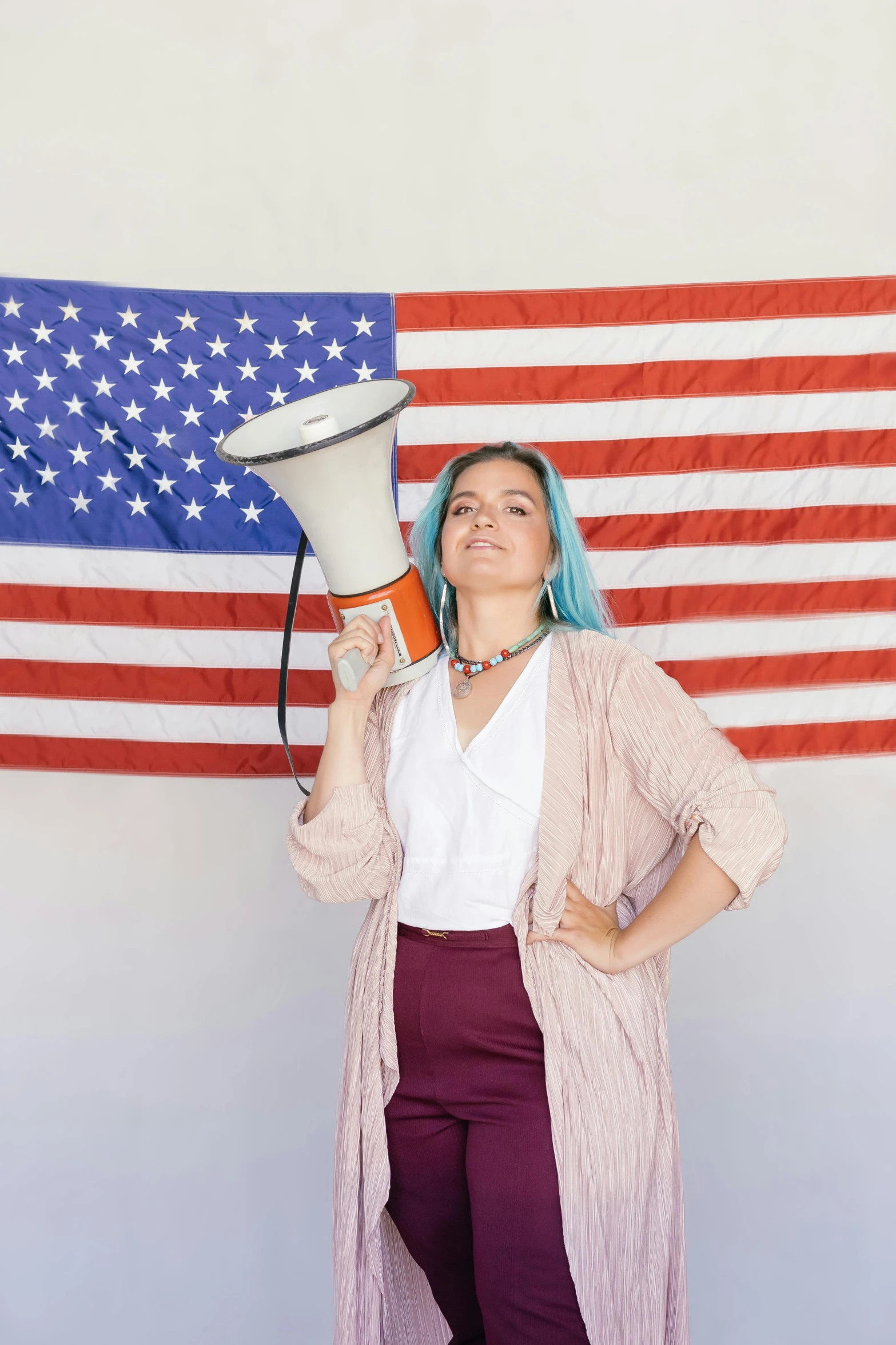 a woman holding a megaphone in front of an american flag, unsplash, renaissance, short blue haired woman, pokimane, politicians, vine