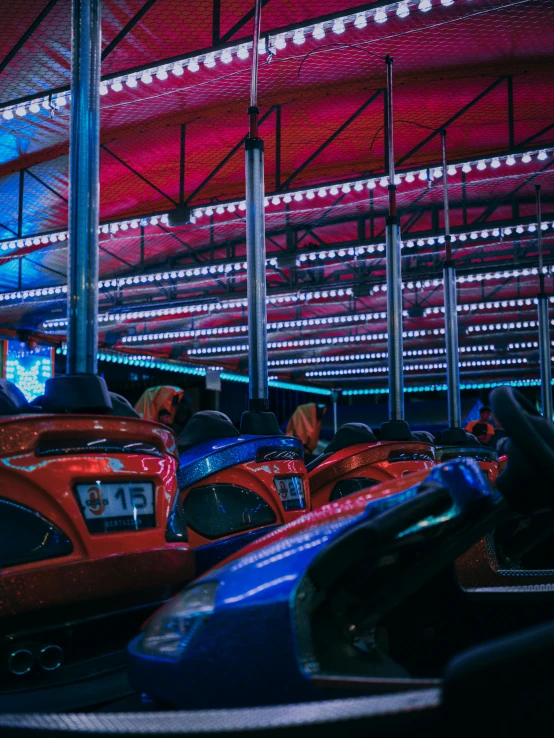 a group of people riding on top of bumper cars, inspired by Elsa Bleda, pexels contest winner, les automatistes, red and blue black light, cars parked underneath, 2 5 6 x 2 5 6 pixels, nostalgic and melancholic 4 k