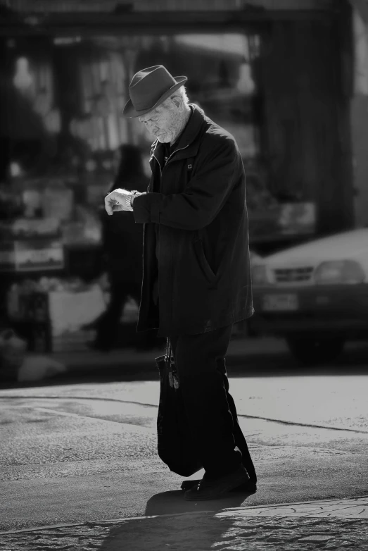 a black and white photo of a man walking down the street, pexels contest winner, happening, praying with tobacco, cyberpunk old man, standing in time square, on a parking lot