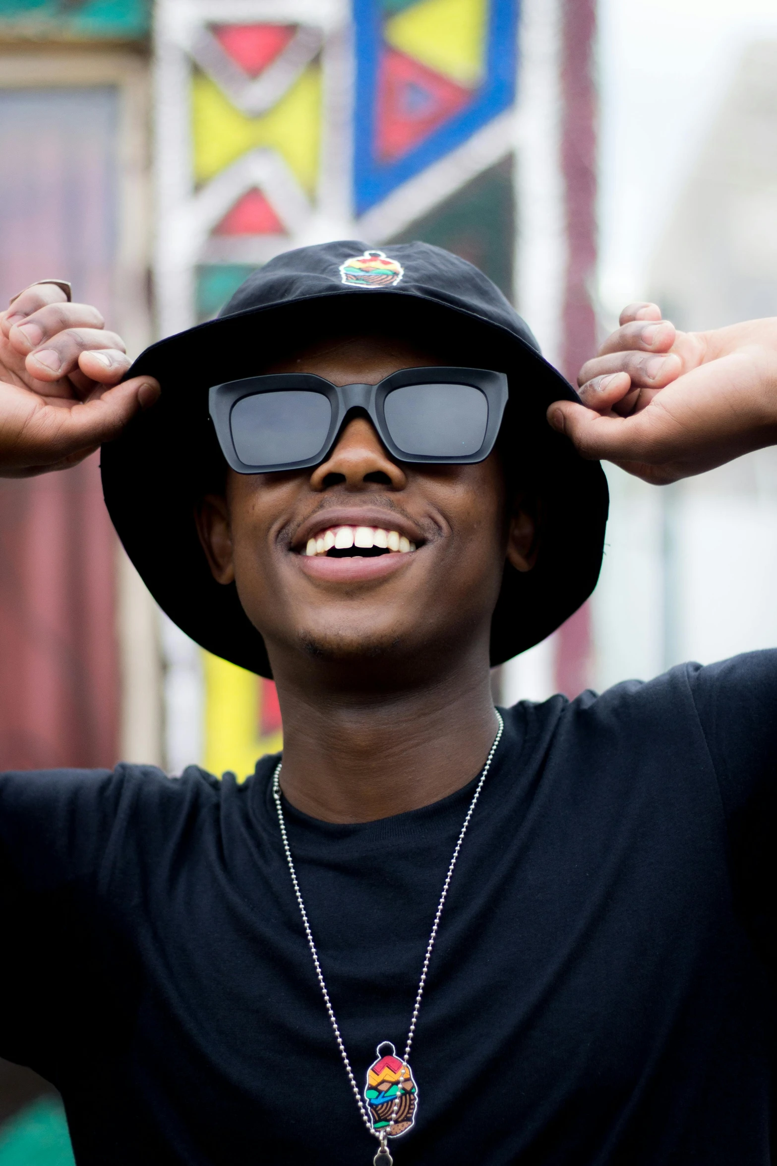 a close up of a person wearing a hat and sunglasses, an album cover, black teenage boy, smiling playfully, in 2 0 1 5, black hat