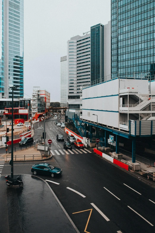 a city street filled with lots of traffic next to tall buildings, unsplash, futuristic france, under construction, low quality photo, billboard image