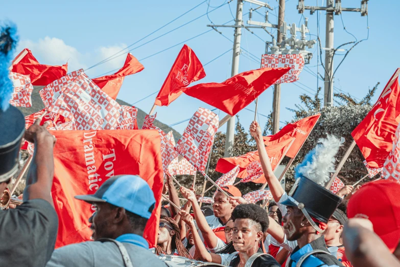 a large group of people holding red flags, an album cover, by Sam Dillemans, pexels contest winner, happening, jamaica, parade setting, 🚿🗝📝, “diamonds