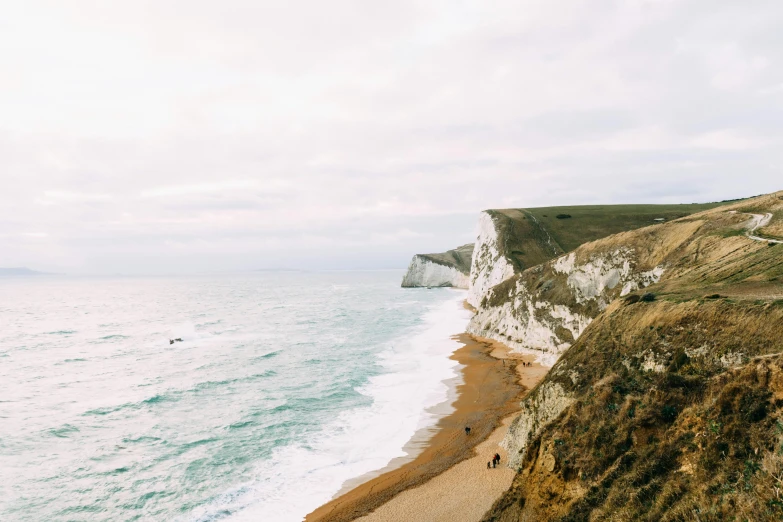 a man standing on top of a cliff next to the ocean, by Rachel Reckitt, pexels contest winner, renaissance, chalk cliffs above, people angling at the edge, slightly pixelated, farming