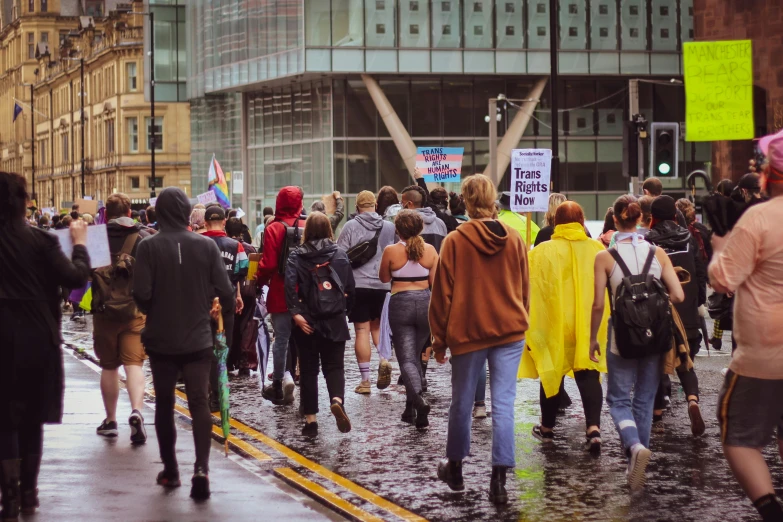 a group of people walking down a wet street, pexels, protest, manchester, trans rights, 2 0 2 2 photo