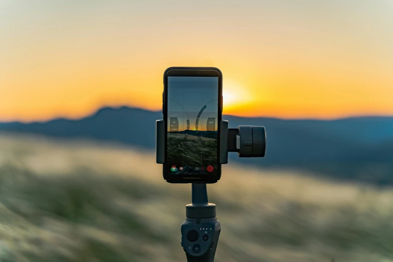 a cell phone sitting on top of a tripod, unsplash contest winner, panoramic anamorphic, at golden hour, fan favorite, tiktok video