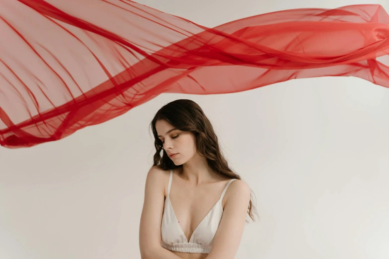 a woman in a white dress with a red scarf over her head, by Emma Andijewska, unsplash contest winner, romanticism, soft translucent fabric folds, bralette, various posed, wearing red tank top