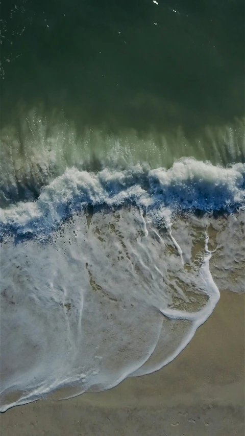 a person riding a surfboard on top of a sandy beach, from above, stream of water, unsplash 4k, houdini fluid simulation