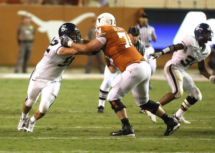 a group of men playing a game of football, by Kyle Lambert, happening, has horns: a sharp, zach hill, ox, file photo