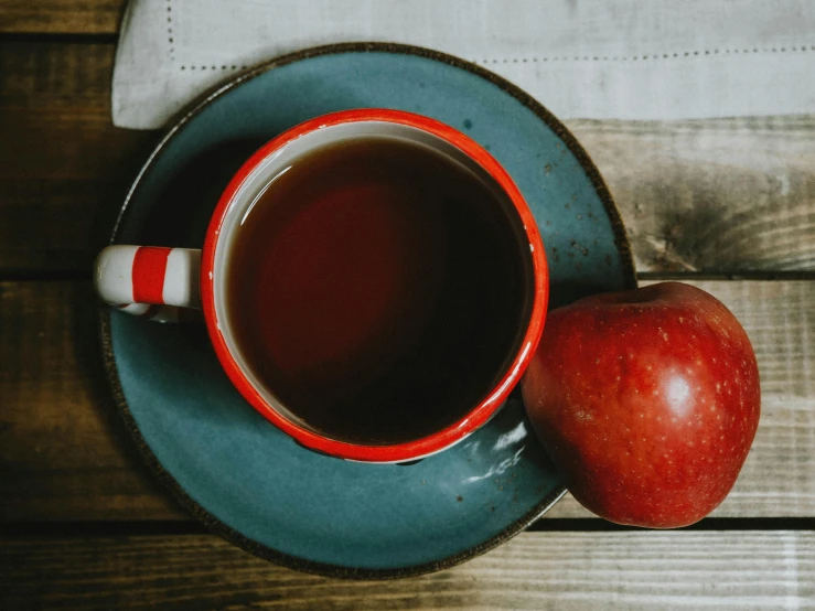 a cup of tea and an apple on a plate, pexels contest winner, brown red blue, vintage aesthetic, square, background image
