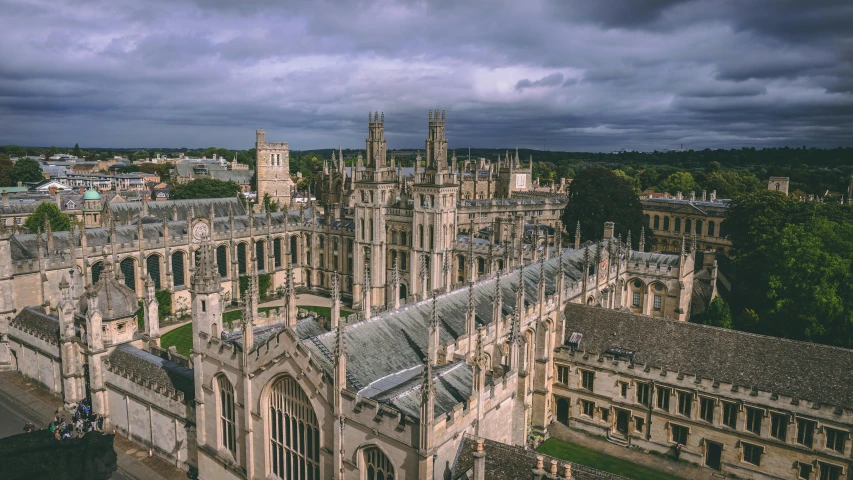 a large building sitting on top of a lush green field, by IAN SPRIGGS, pexels contest winner, renaissance, daniel oxford, skyline showing, dark university aesthetic, silver，ivory