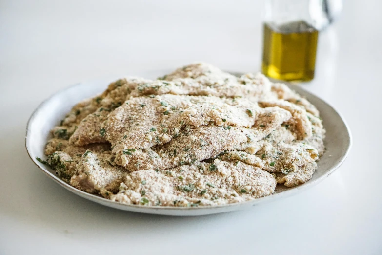 a close up of a plate of food on a table, natural grizzled skin, olive oil, piled around, crust